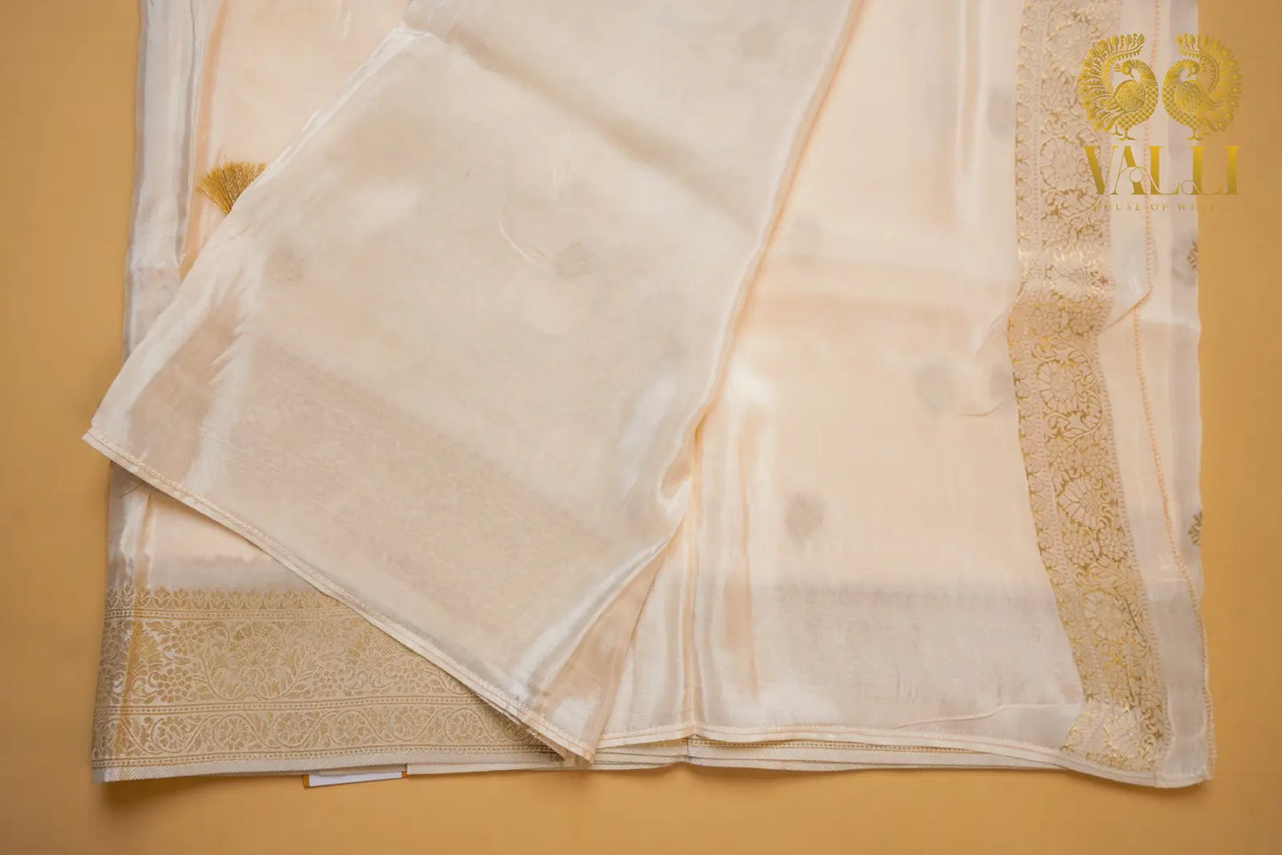 White satin crepe with gold Zari border